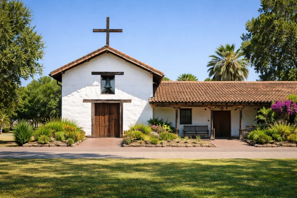 Mission San Francisco Solano in Sonoma California showing white adobe facade bell tower and wooden doors